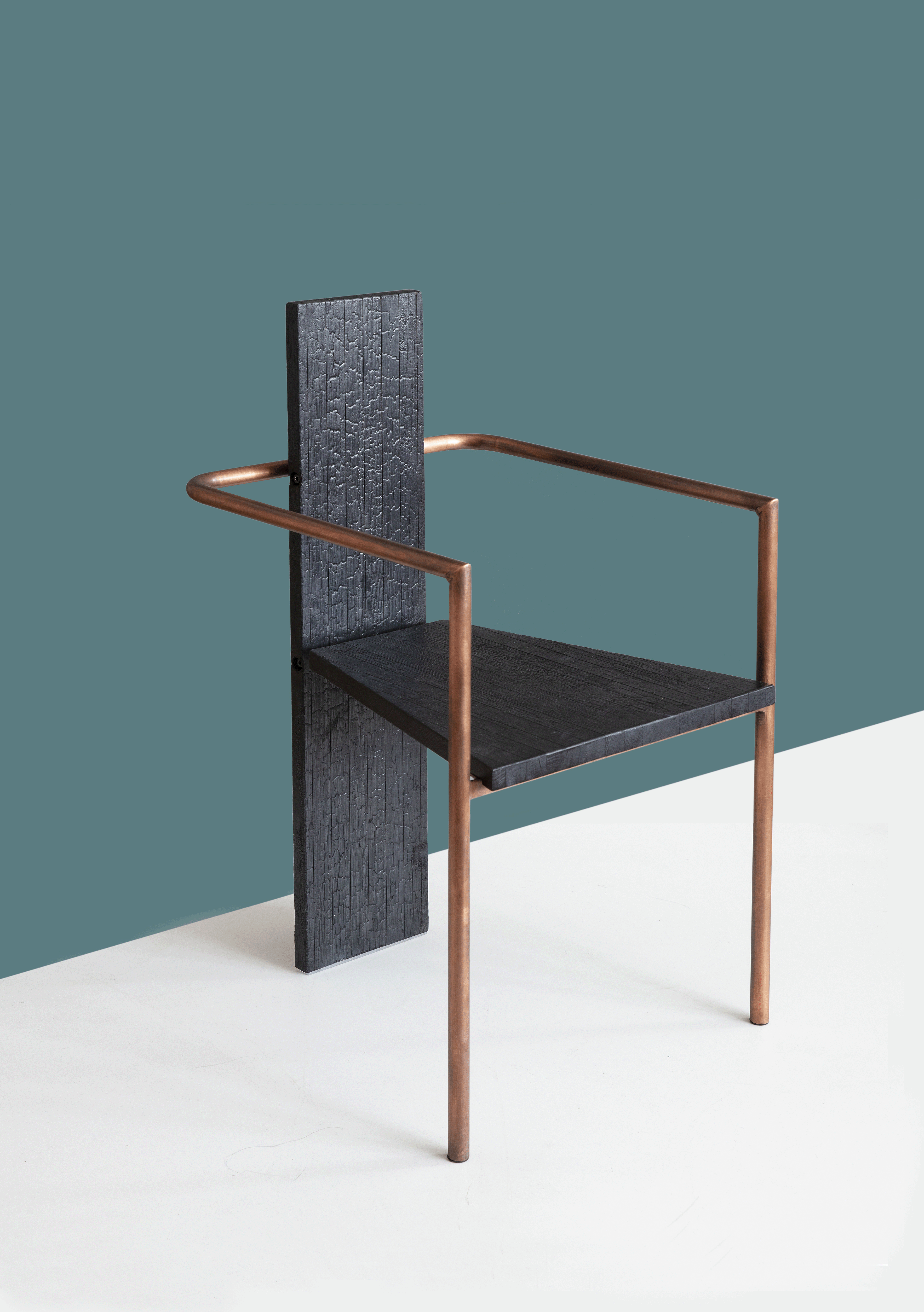 Concrete chair in the KOL finish against a green background.