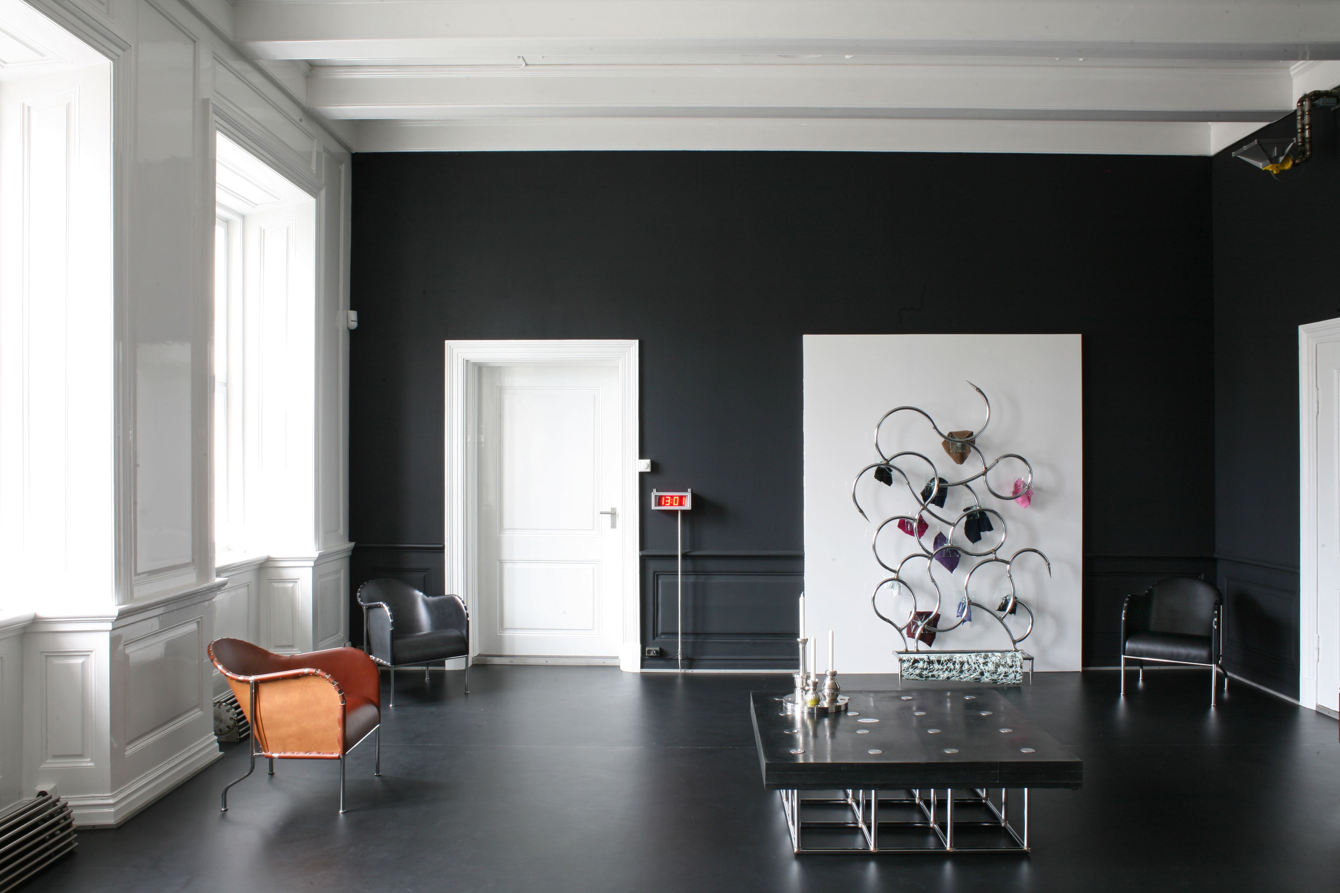 Bruno armchair in a room with dark walls and a light ceiling.