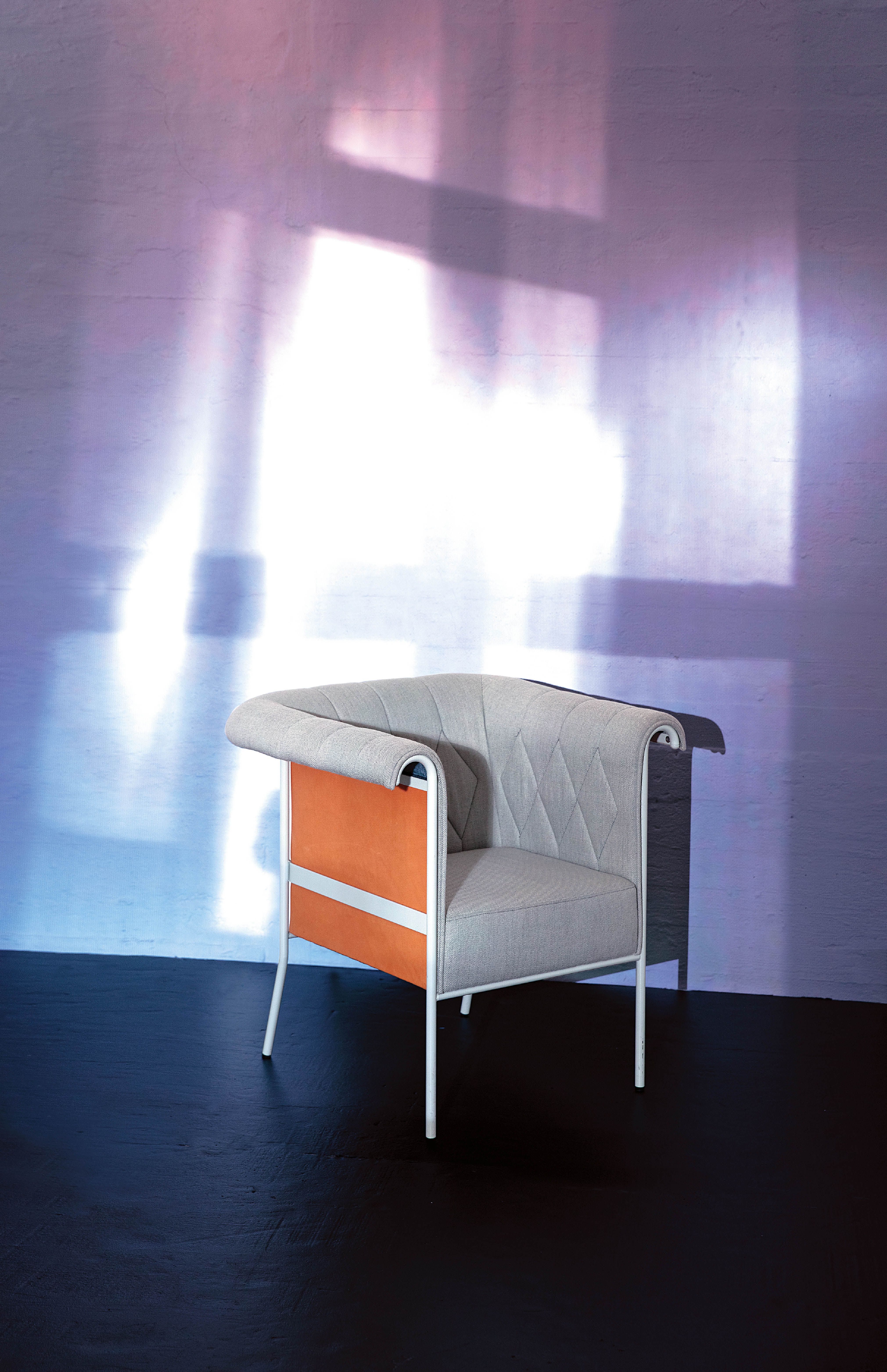 Chester armchair against an illuminated wall.